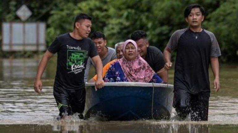 Quelque 28.000 Malaisiens fuient les inondations, des villageois évacués en pelleteuse