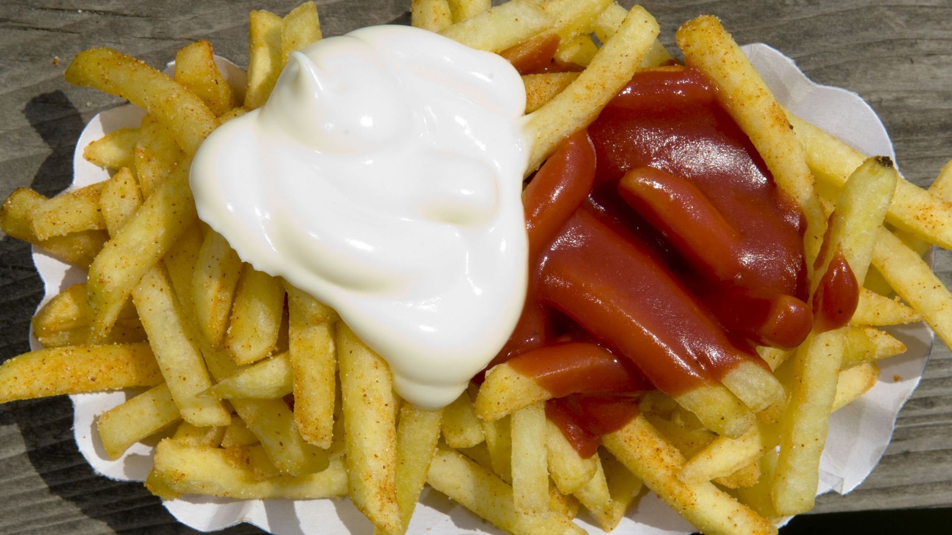 Close-up of chips with mayonnaise and ketchup