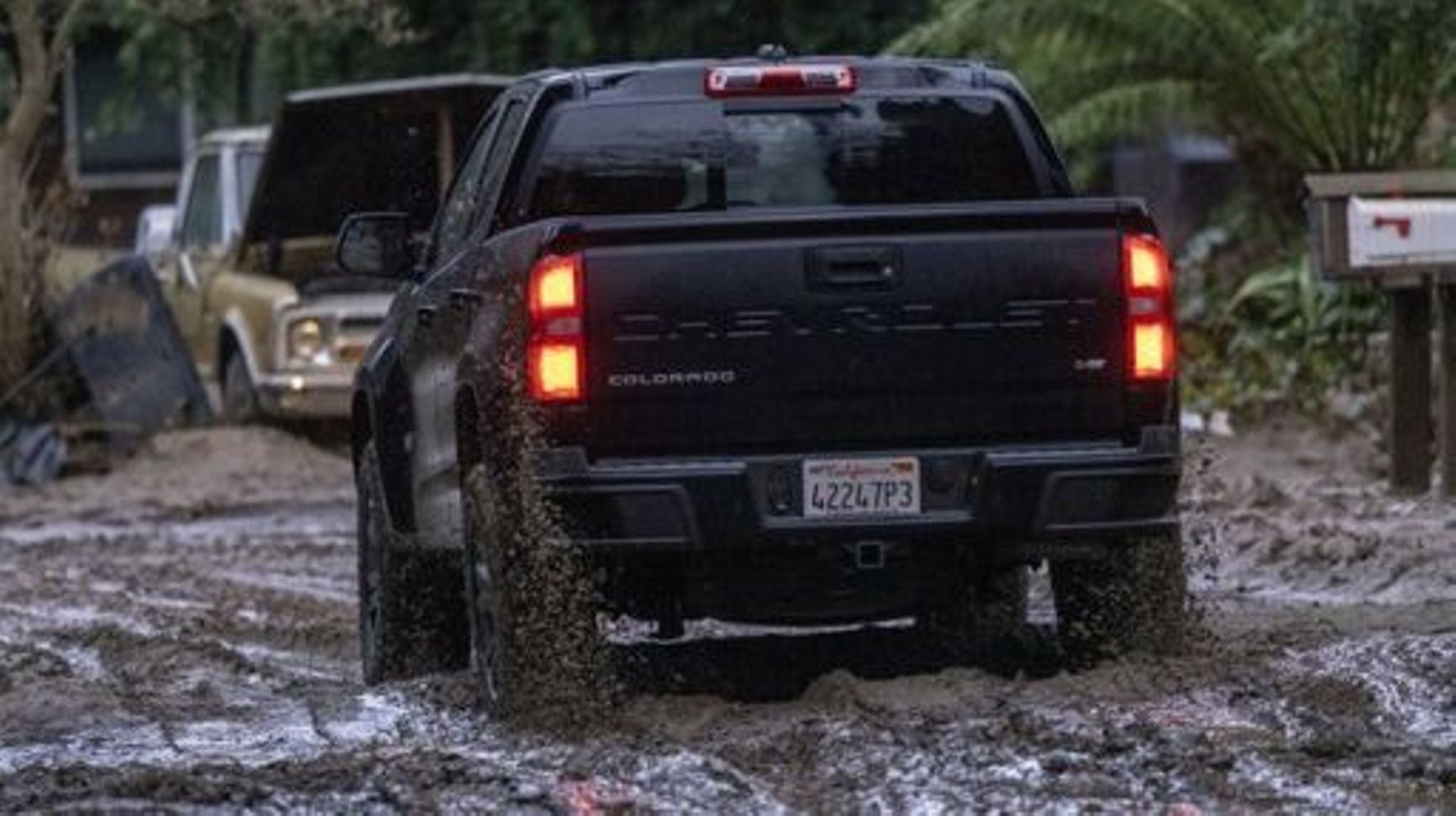 A truck drives along a muddy street in Felton, California, on January 14, 2023 as a series of atmospheric river storms continues to cause widespread destruction across the state.  The latest in a damaging succession of storm systems blew into California o