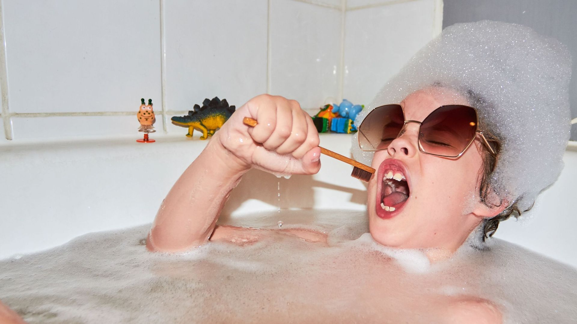 Child singing in bubble bath