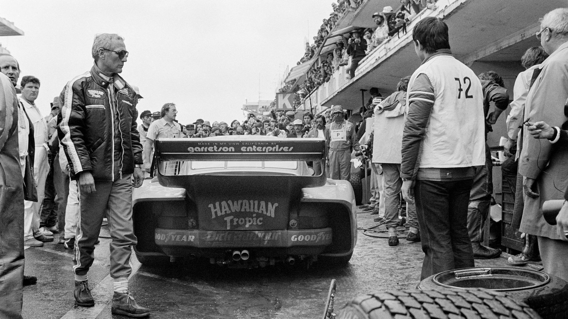 L’acteur américain Paul Newman marche dans les stands, le 9 juin 1979 avant de participer à la 47e édition des 24 heures du Mans sur la Porsche 935.