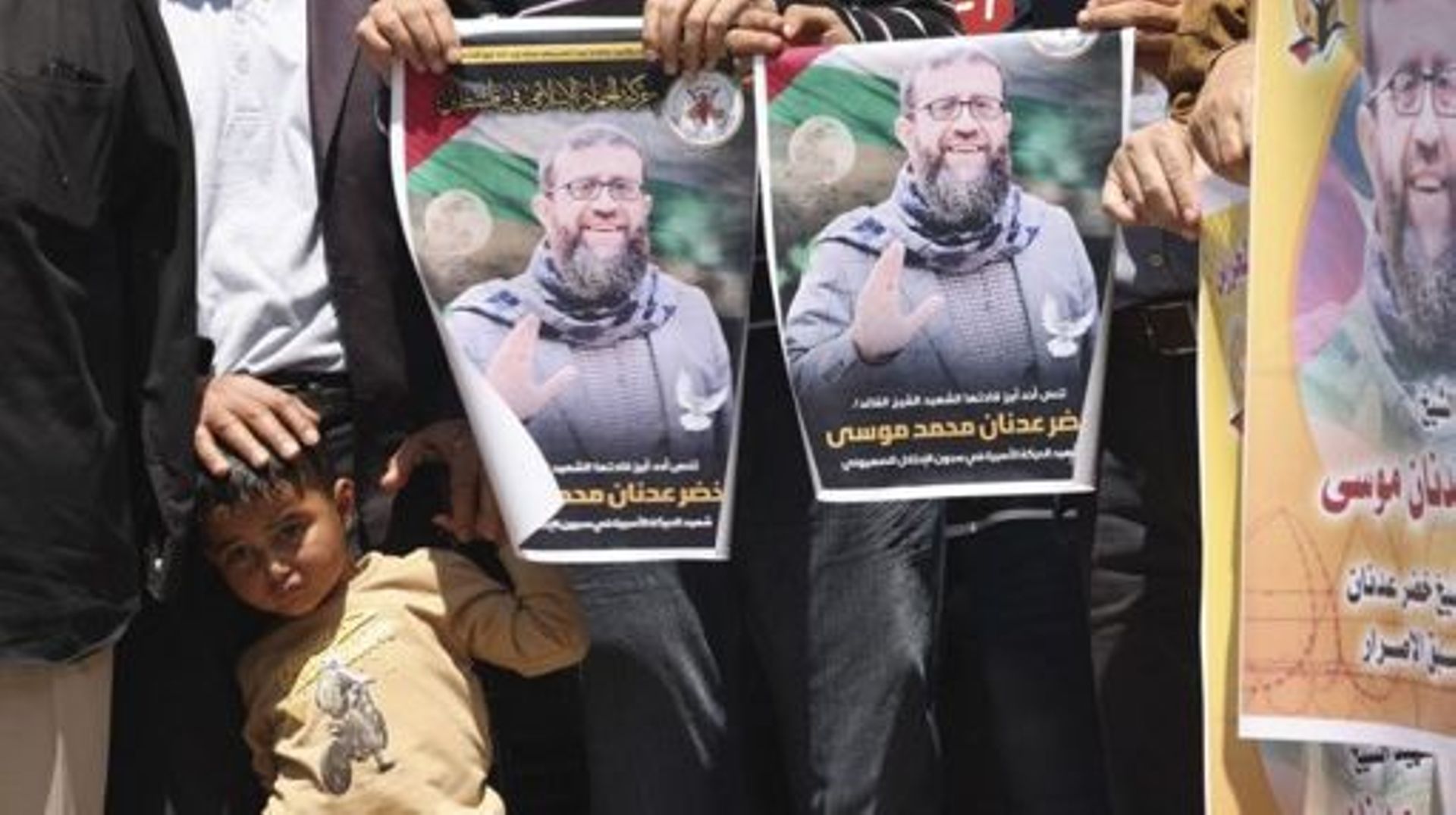 People hold portraits of Khader Adnan, a Palestinian Islamic Jihad militant who had been on hunger strike in prison for nearly three months, during a rally following the announcement of his death, on May 2, 2023, in Gaza City. Israel’s prison service anno