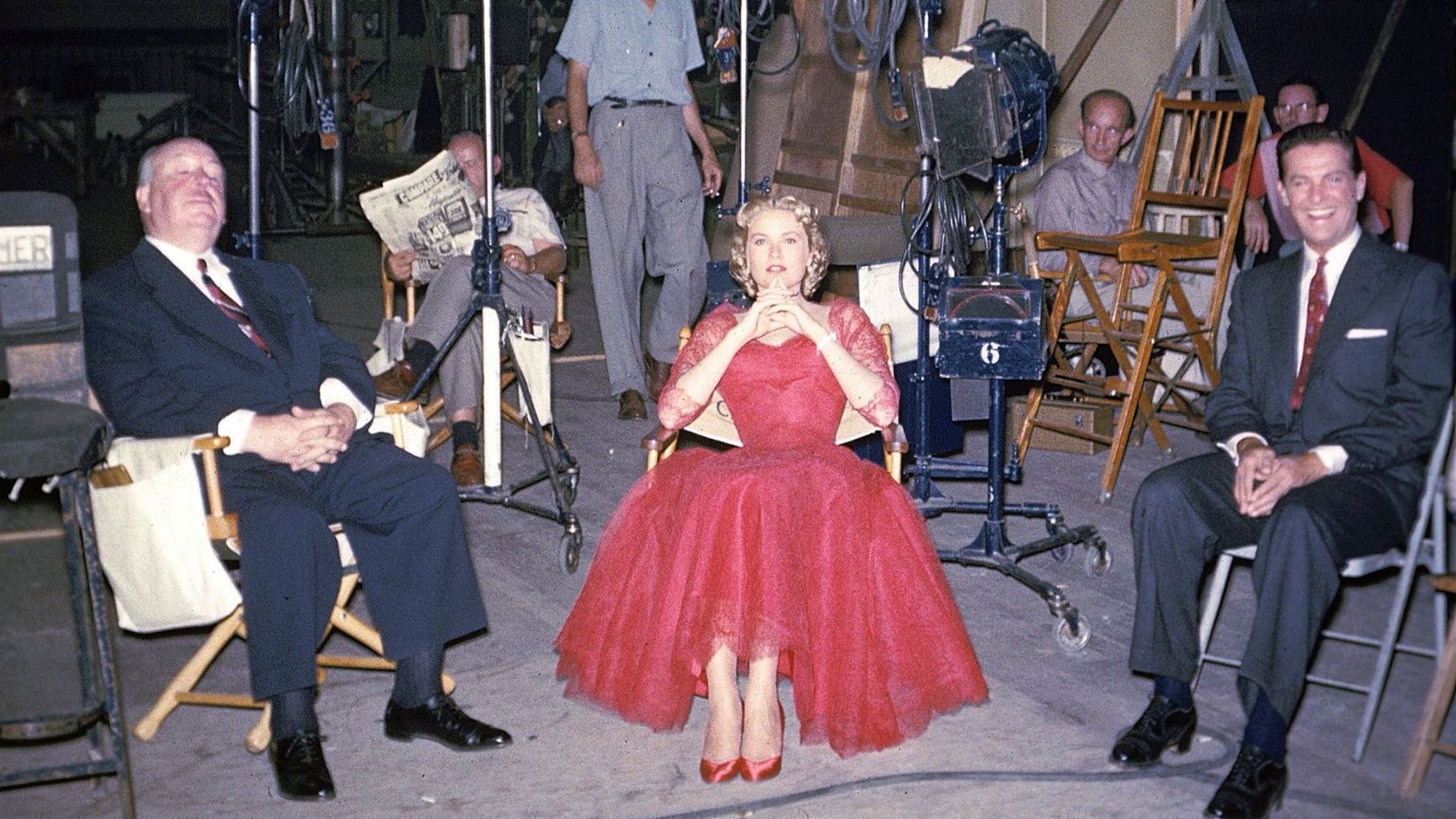 British director and producer Alfred Hitchcock, american actress Grace Kelly and american actor Robert Cummings on the set of the movie Dial M for Murder.