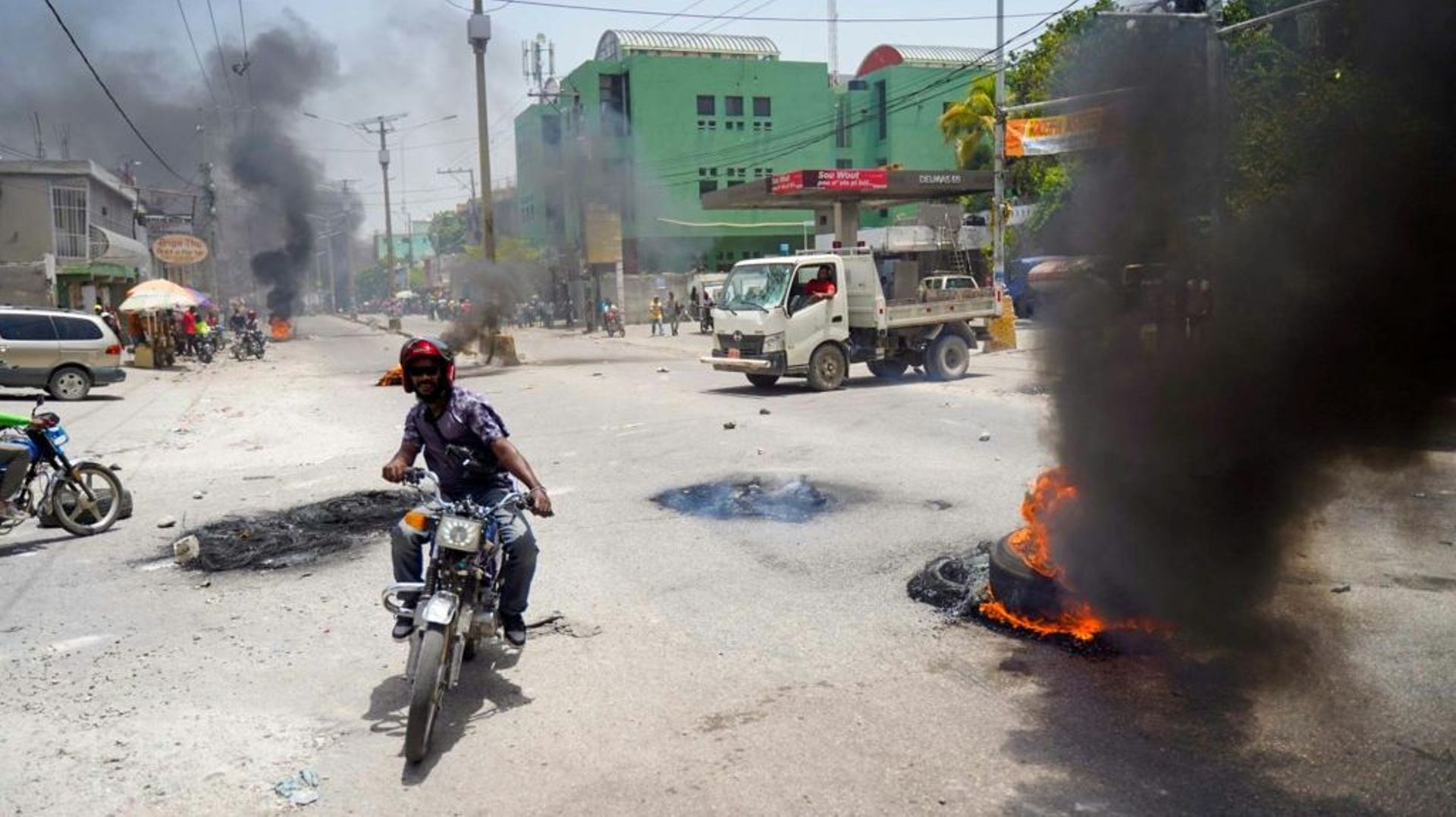 Un homme sur une moto lors d'une manifestation contre la hausse des prix à Port-au-Prince, en Haïti, le 13 juillet 2022