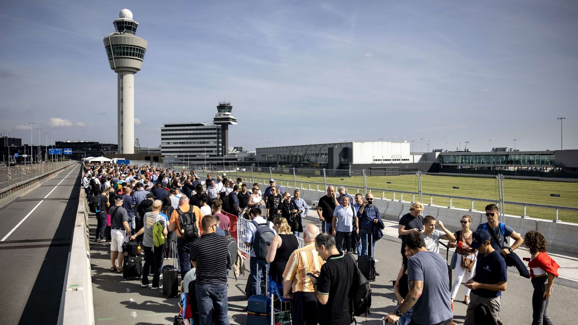 Des voyageurs font la queue à l'aéroport de Schiphol, le 12 septembre 2022, après que l'aéroport a demandé à plusieurs compagnies aériennes d'annuler des vols en raison d'une pénurie de personnel de sécurité.