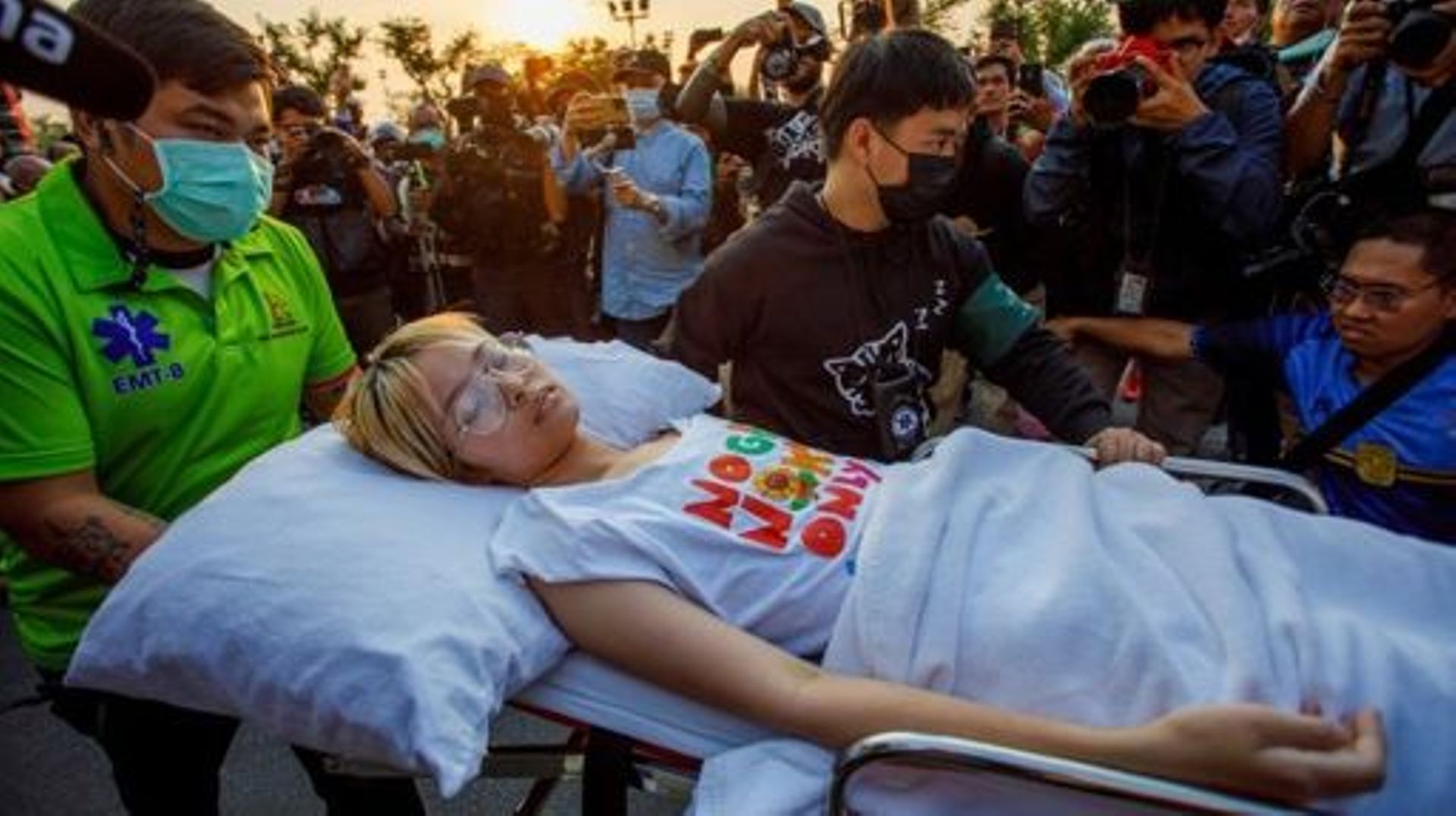 This photo taken on February 24, 2023 shows Thai political activist Orawan "Bam" Phuphong being transported on a stretcher to continue a hunger strike outside Thailand’s Supreme Court after being released from Thammasat Hospital in Bangkok. Thai political