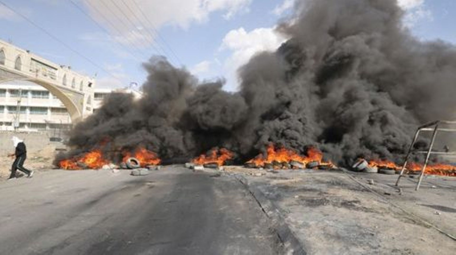 Palestinian protesters burn tyres to block a road leading into Jericho in the occupied West Bank, on February 6, 2023, following a raid in town by Israeli forces. Israeli forces on February 6 killed five alleged Palestinian gunmen in a raid in the occupie