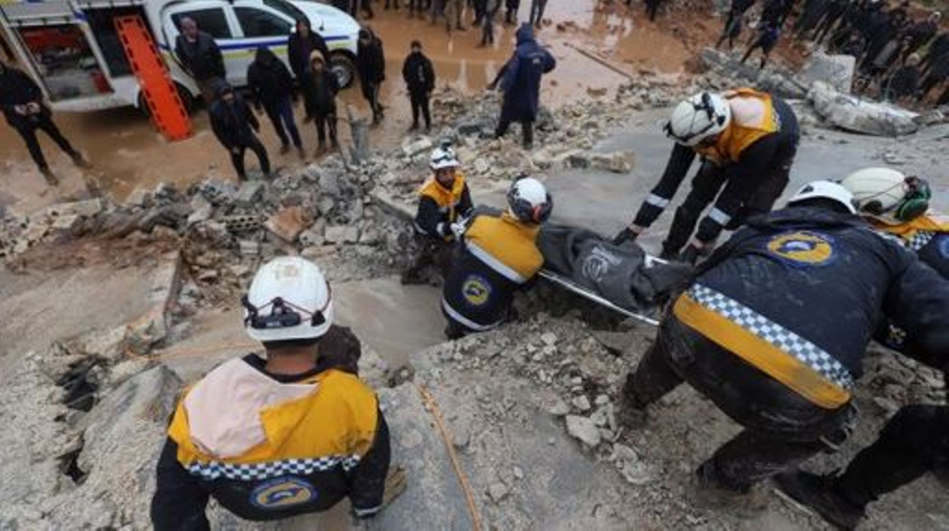 Members of the Syrian civil defence, known as the White Helmets transport a casualty pulled from the rubble following an earthquake in the town of Zardana in the countryside of the northwestern Syrian Idlib province, early on February 6, 2023. A 7.8-magni