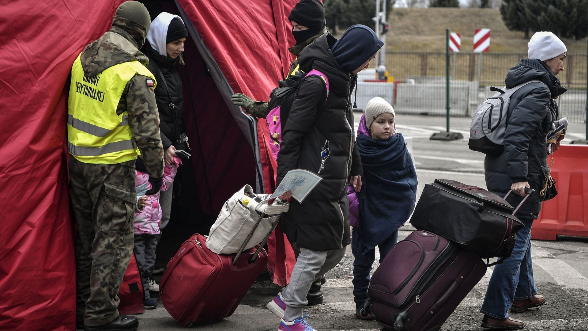 Des réfugiés ukrainiens traversent la frontière avec la Pologne, à Korczowa, le 10 mars 2022.