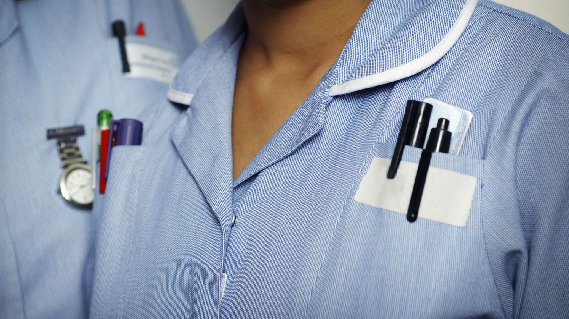 UK, Close-up of two typically dressed NHS (National Health Service) nurses