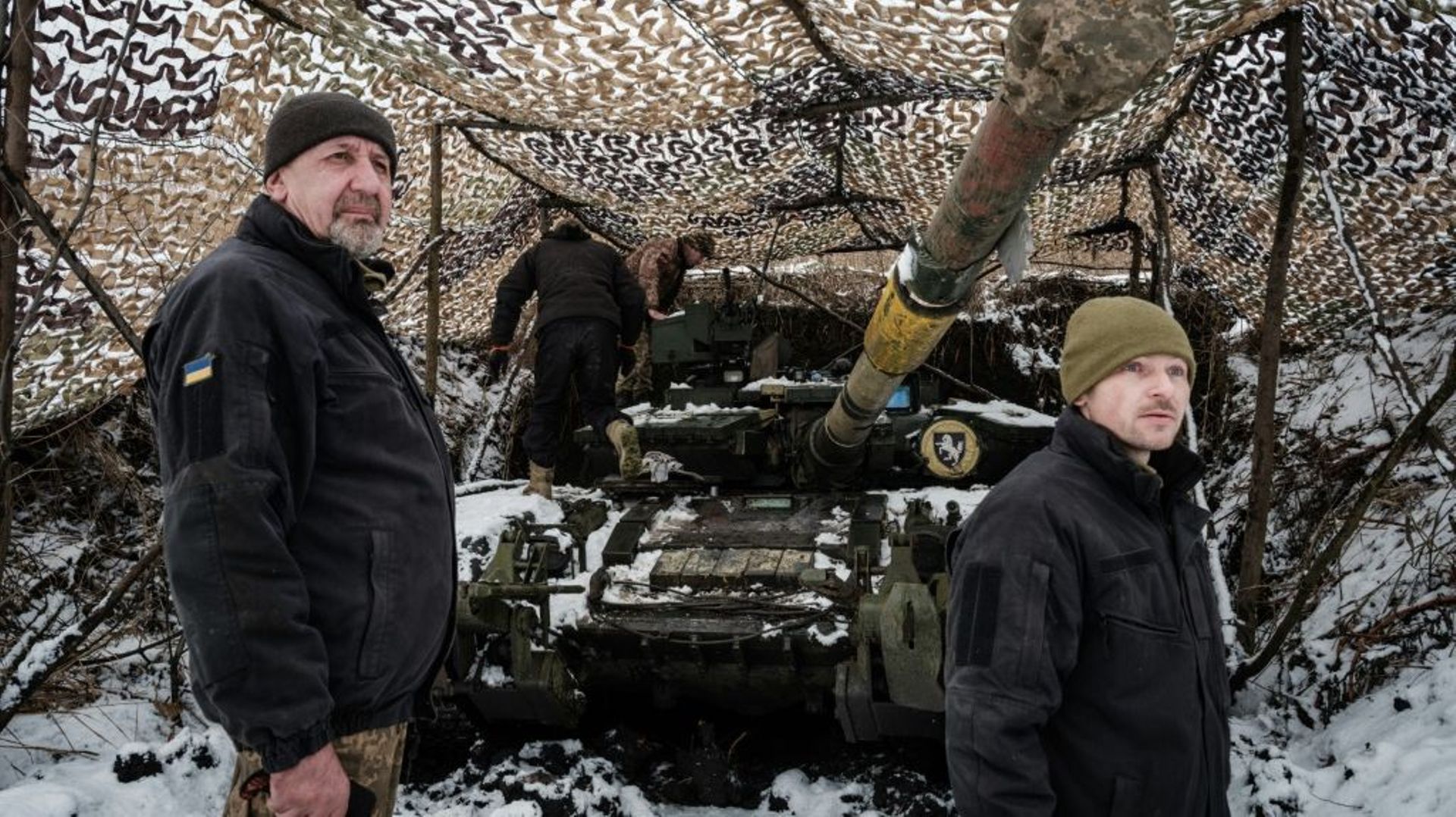 Volodymyr, à gauche, devant son char T-64 près de la ligne de front, dans l'est de l'Ukraine, le 4 février 2023