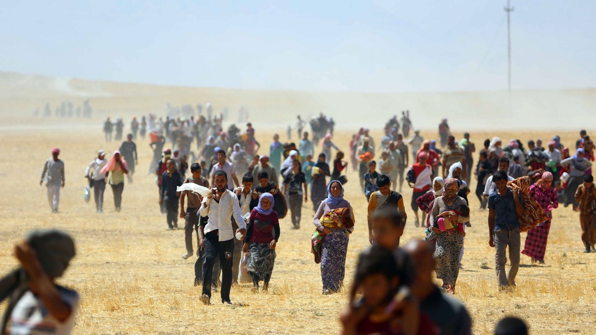 Des milliers de Yézidis piégés dans les montagnes de Sinjar alors qu'ils tentaient d'échapper aux forces de l'État islamique (EI), sont secourus par les forces peshmerga kurdes et l'unité de protection du peuple (YPG) à Mossoul, en Irak, le 09 août 2014.