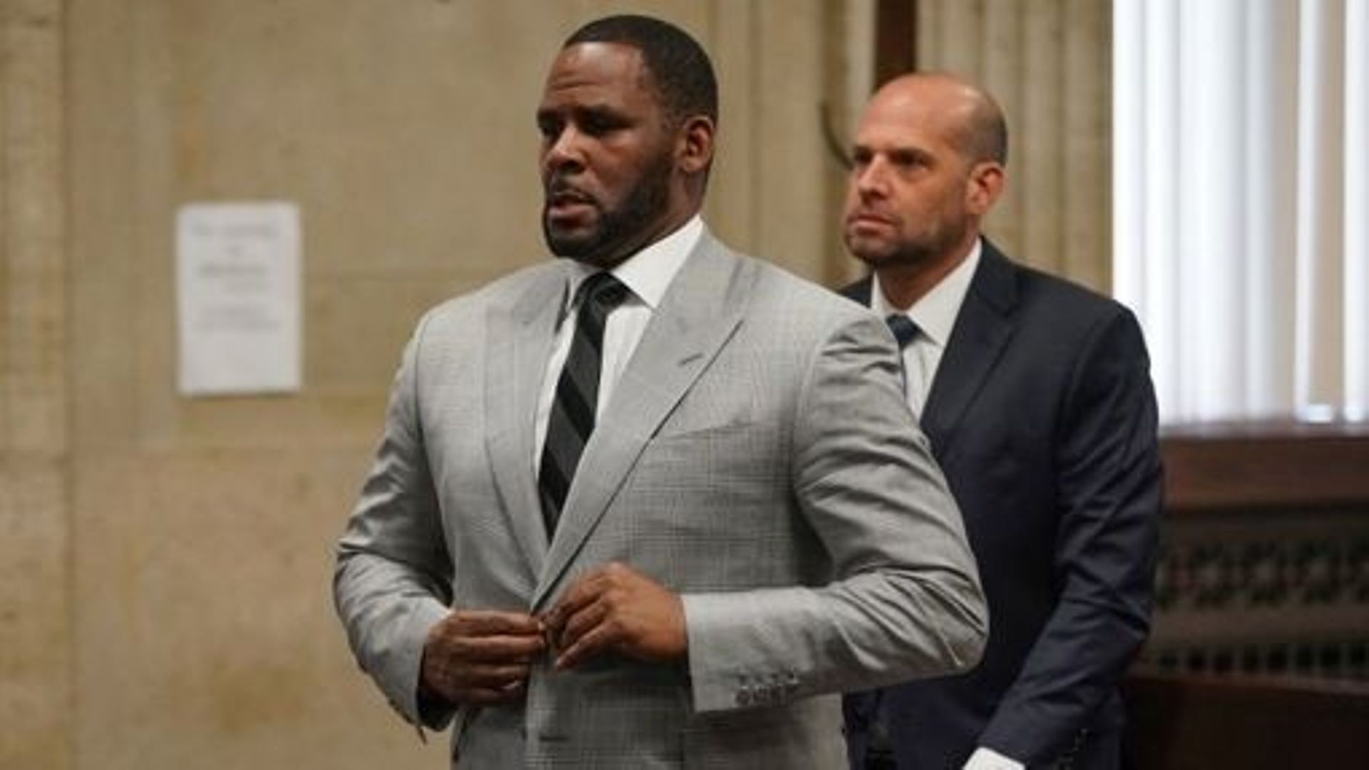(FILES) In this file photo taken on June 06, 2019 R. Kelly pleads not guilty to a new indictment before Judge Lawrence Flood at Leighton Criminal Court Building in Chicago.  A US judge on February 23, 2023 sentenced the disgraced R&B singer R. Kelly to a 