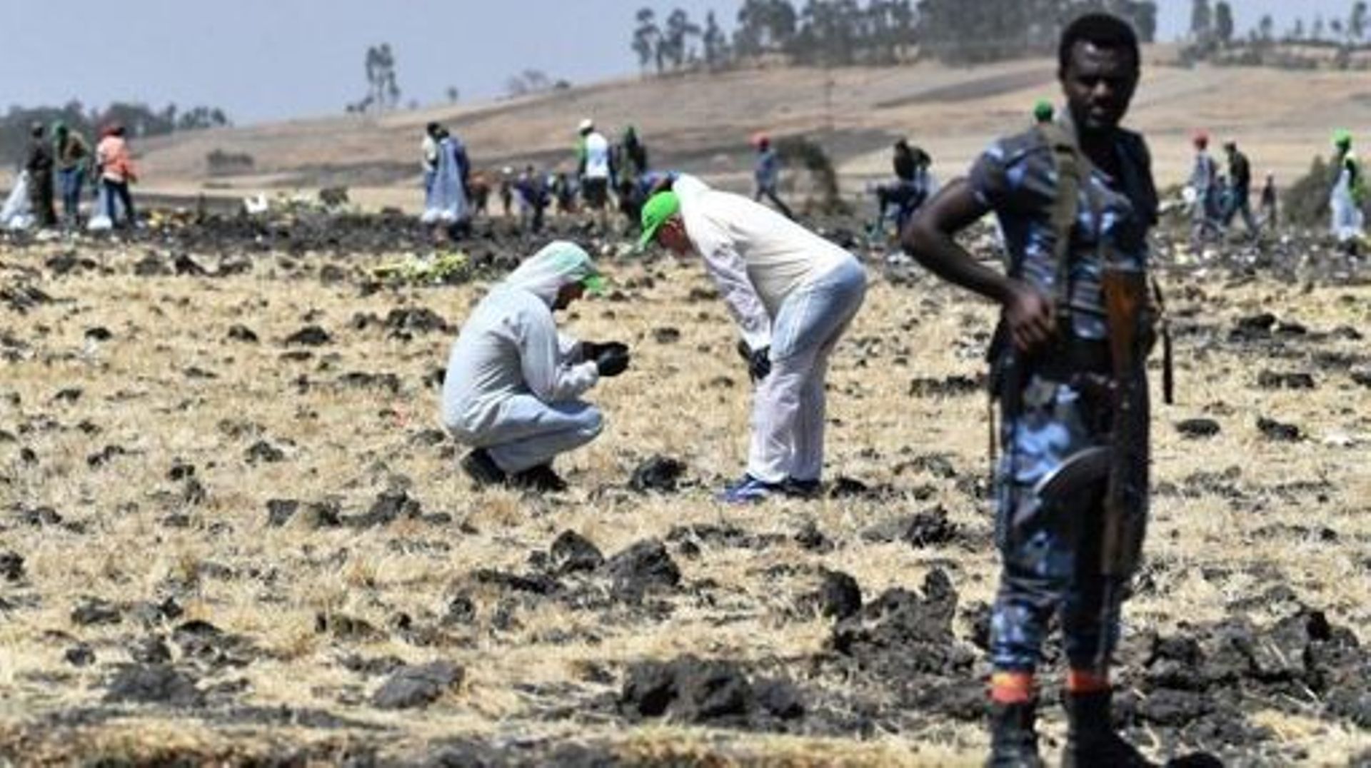 Forensic experts work at the crash site of the Ethiopian Airlines operated Boeing 737 MAX aircraft, at Hama Quntushele village in the Oromia region, on March 13, 2019. A Nairobi-bound Ethiopian Airlines Boeing crashed minutes after takeoff from Addis Aba