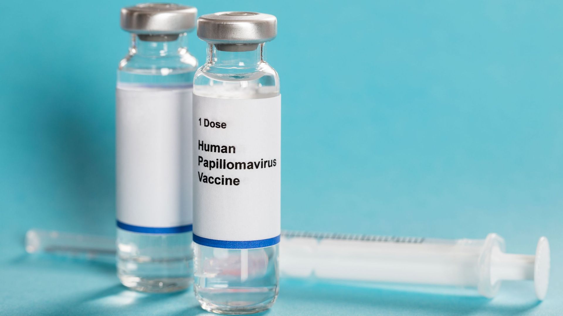 Human Papillomavirus Vaccine In Bottles With Syringe.