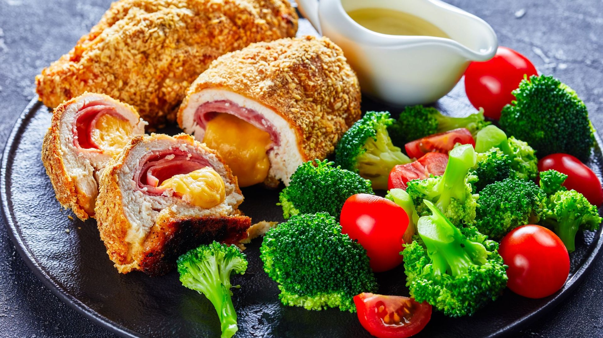 Chicken Cordon Bleu baked in oven with ham and cheese stuffing