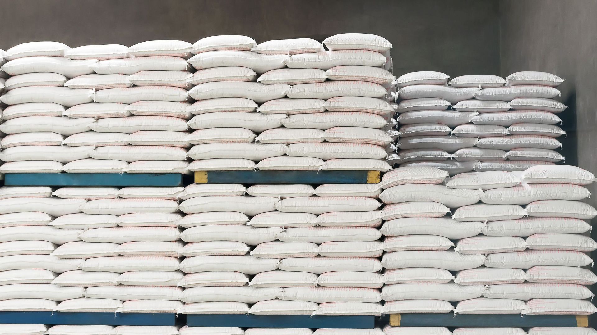 Animal feed bag food pallet system stacking in smart industry warehouse factory. Agricultural concept.