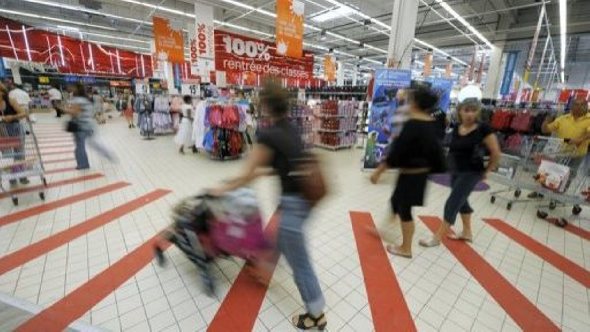 Des personnes font leurs achats dans un hypermarché à Ecully, près de Lyon