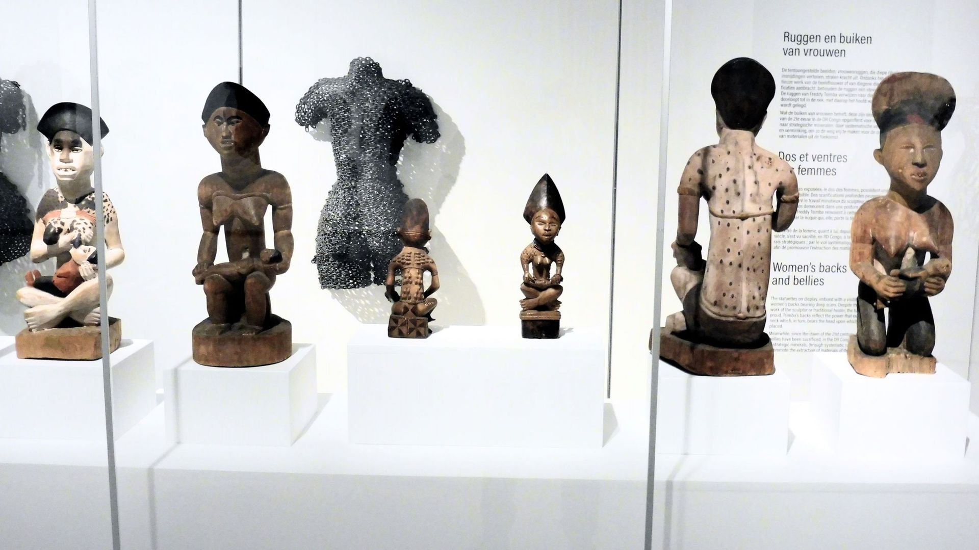 Statues de mère et enfant issues des collections de l'AfricaMuseum en regard d'une oeuvre de Freddy Stimba