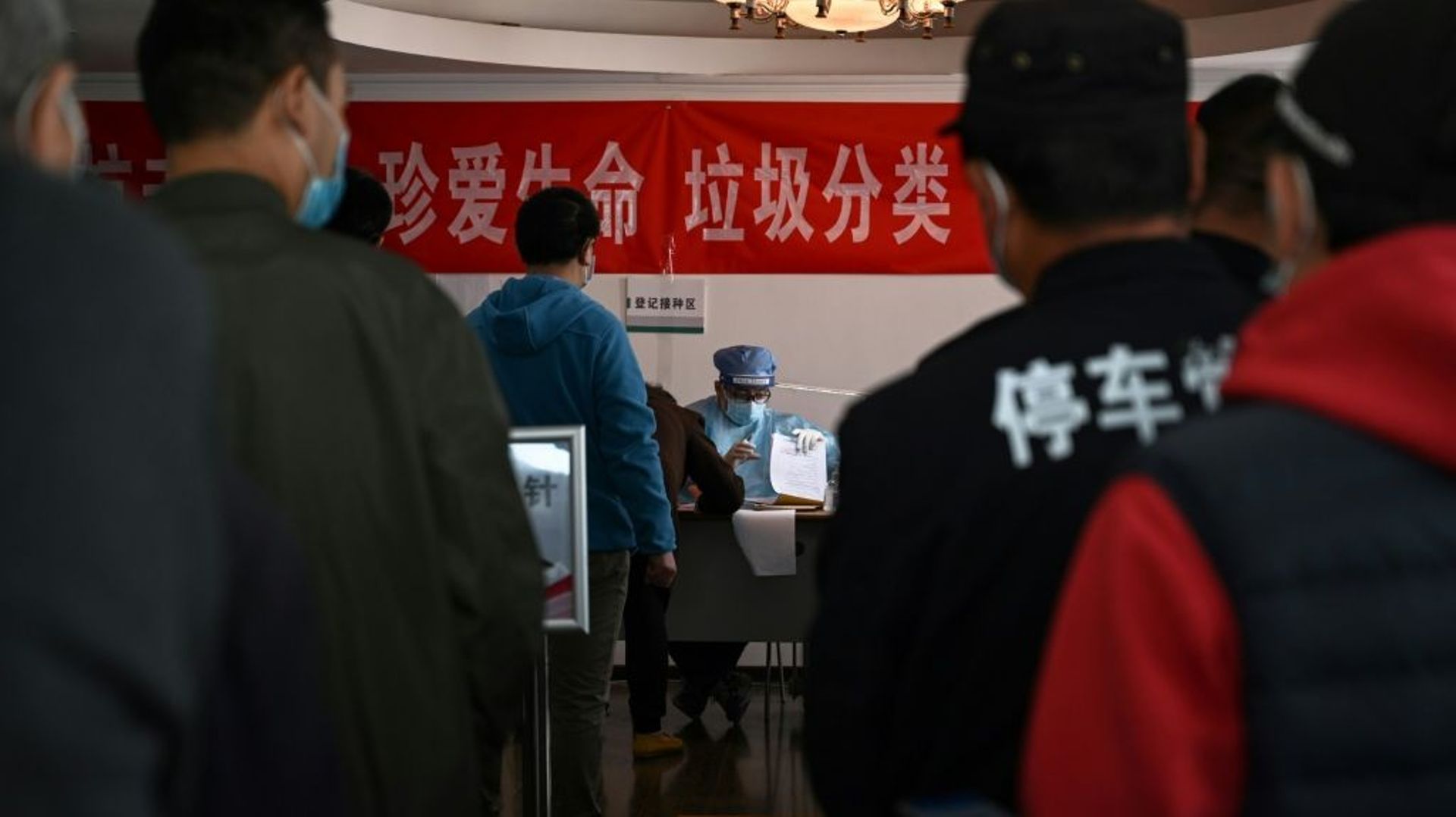 Des personnes patientent pour se faire vacciner contre le Covid-19 dans un centre de vaccination à Pékin, le 8 avril 2021