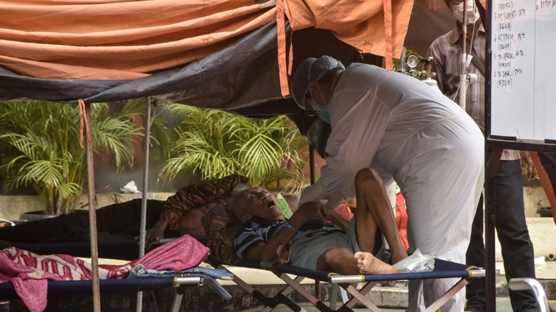 Un patient est traité à l’extérieur d’un hôpital débordé par la flambée de coronavirus, le 14 juillet à Bekasi, en Indonésie