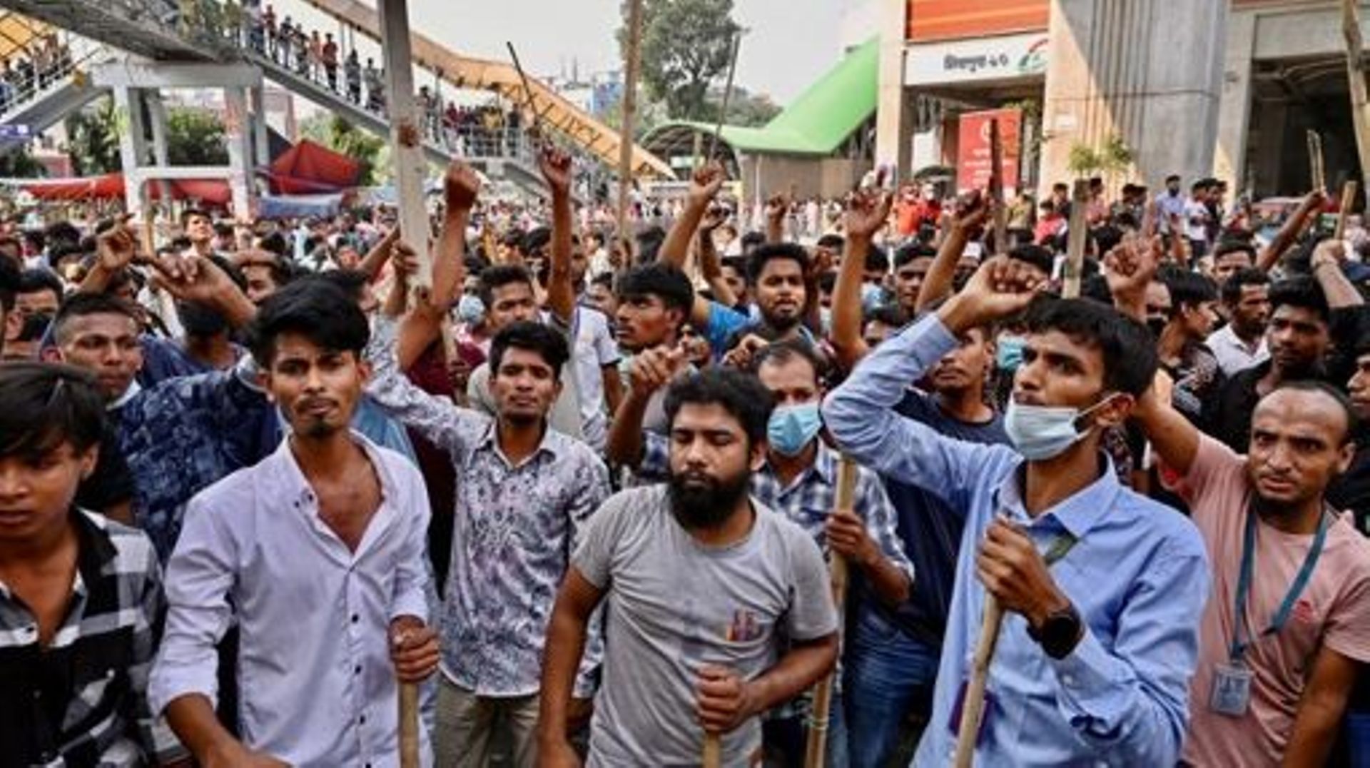 Garment workers block roads as they take part in a protest in Dhaka on November 1, 2023. Thousands of Bangladeshi garment workers barricaded roads in Dhaka Wednesday demanding fair wages for clothing they make for major Western brands, with at least two k