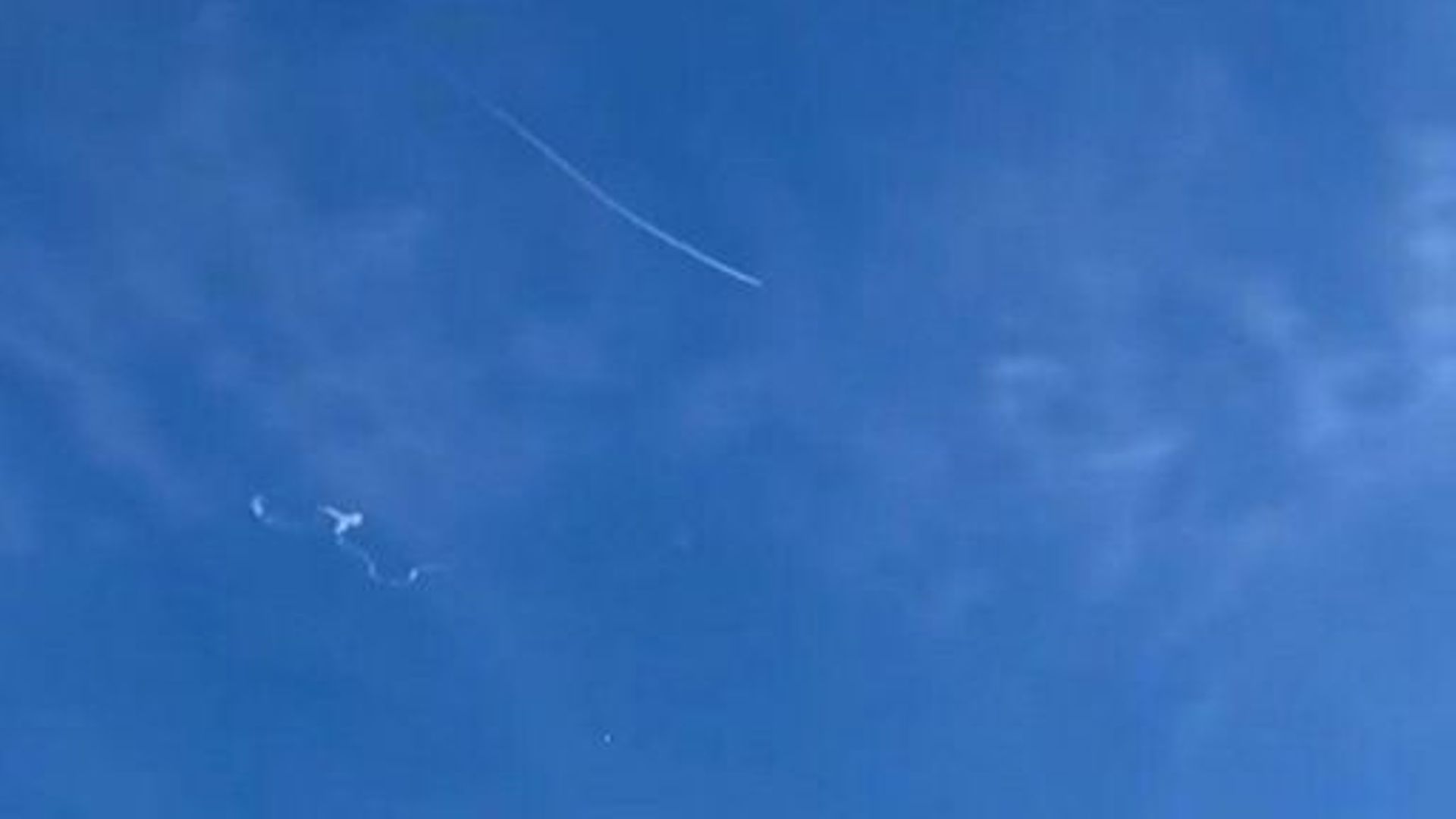 This still image taken from a cellphone video by Haley Walsh in Myrtle Beach, South Carolina, shows a suspected Chinese surveillance balloon after it was shot down (L) on February 4, 2023. A US fighter jet on Saturday shot down the Chinese balloon off the