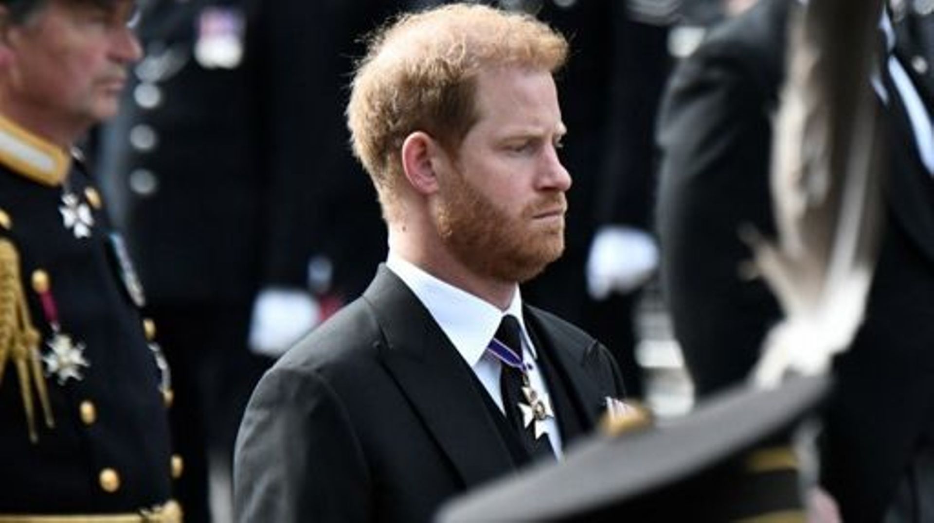 Britain's Prince Harry, Duke of Sussex follows the coffin of Queen Elizabeth II, draped in the Royal Standard, on the State Gun Carriage of the Royal Navy, as it travels from Westminster Abbey to Wellington Arch in London on September 19, 2022, after the 