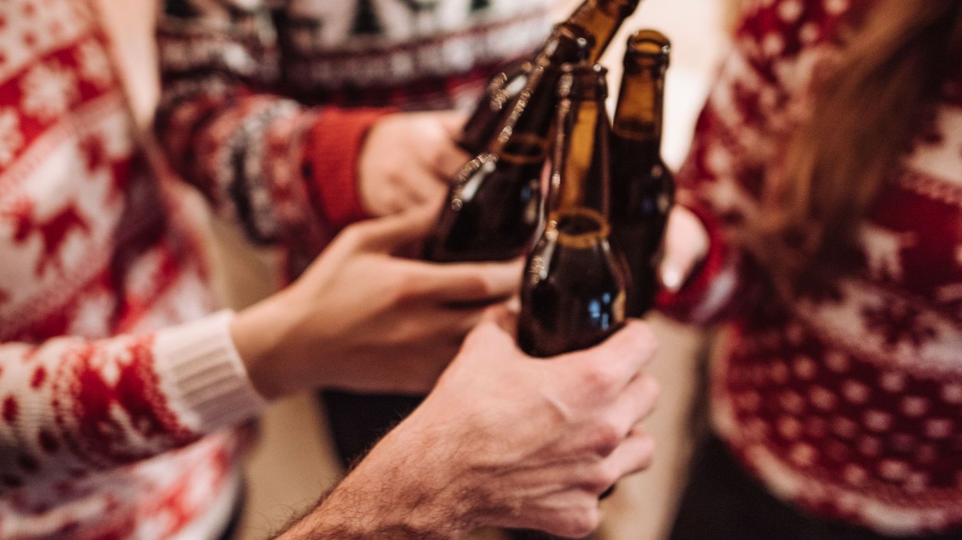 christmas friends toasting beer at home