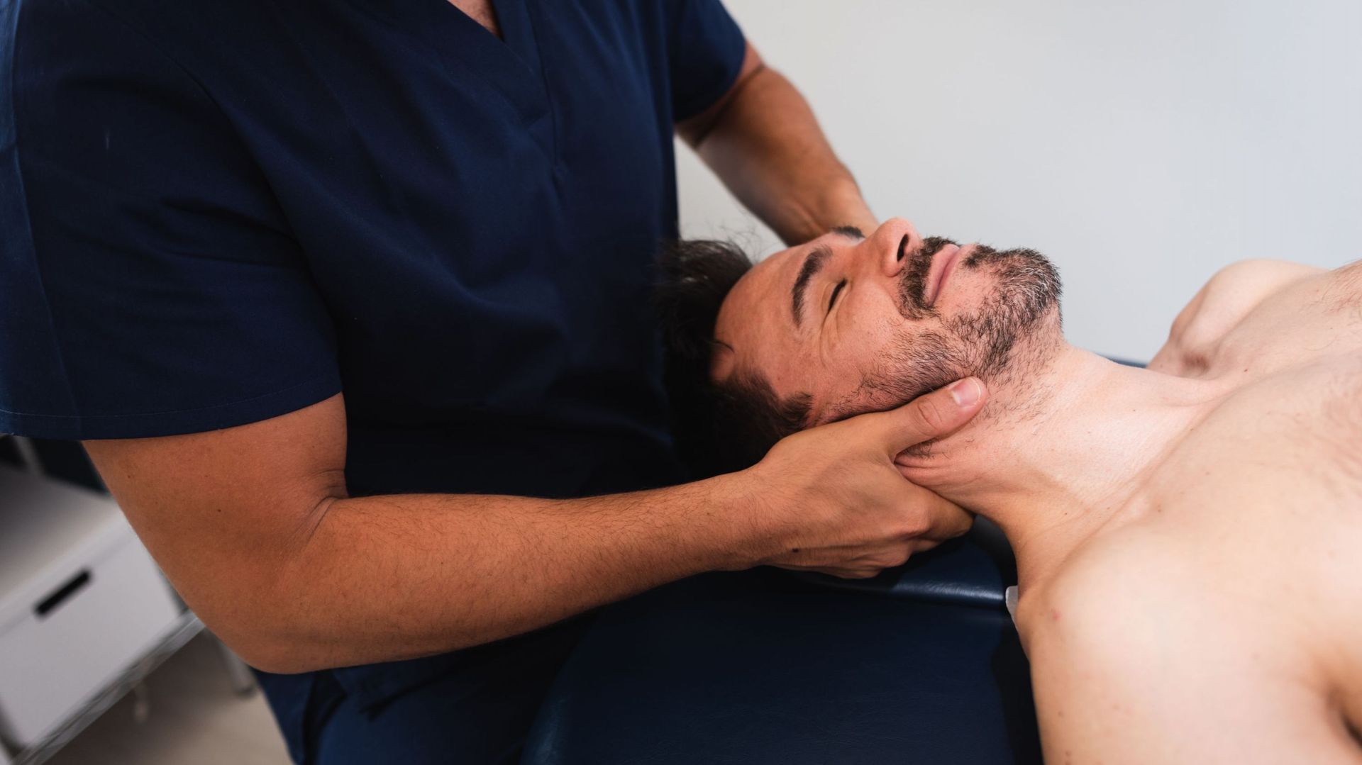 Chiropractor performing an adjustment on a patient&#39 ; s neck