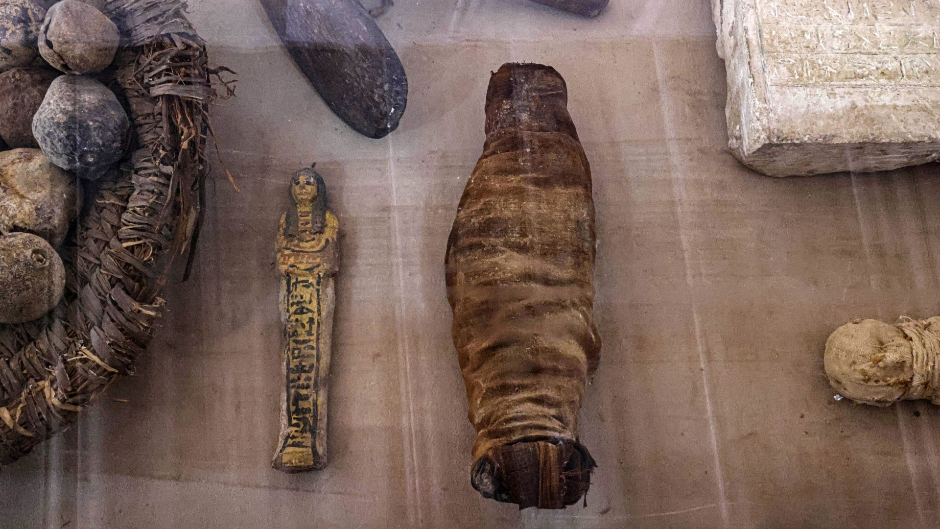 De petits animaux momifiés récemment découverts sont exposés parmi d’autres objets à la nécropole de Saqqarah où des archéologues ont mis au jour deux ateliers d’embaumement humains et animaux ainsi que deux tombes, au sud du Caire le 27 mai 2023.