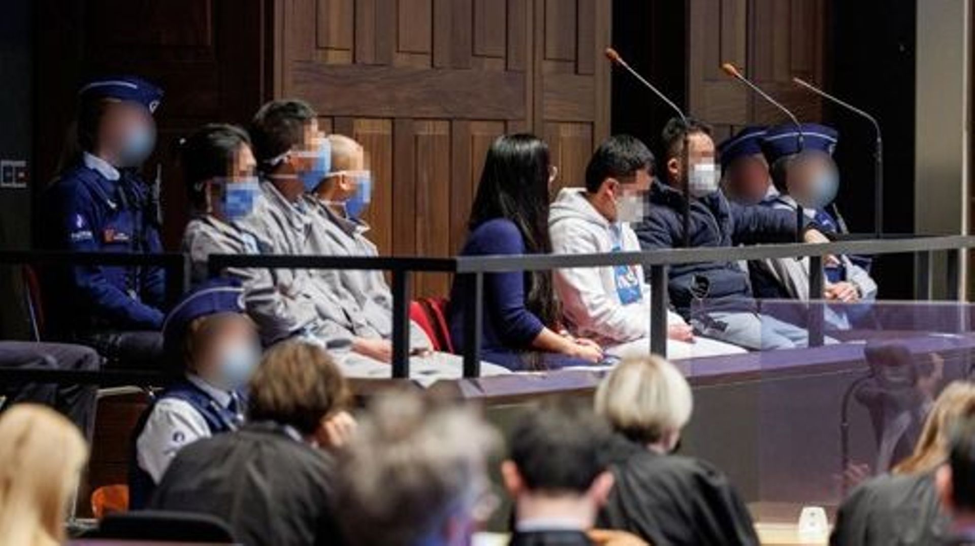 accused Long Nguyen and accused Vo Van Hong pictured during the verdict at the tribunal of first instance, where 23 people are on trial for the dead of 39 Vietnamese migrants, Wednesday 19 January 2022 in Brugge. In October 2019 39 people were found dead 