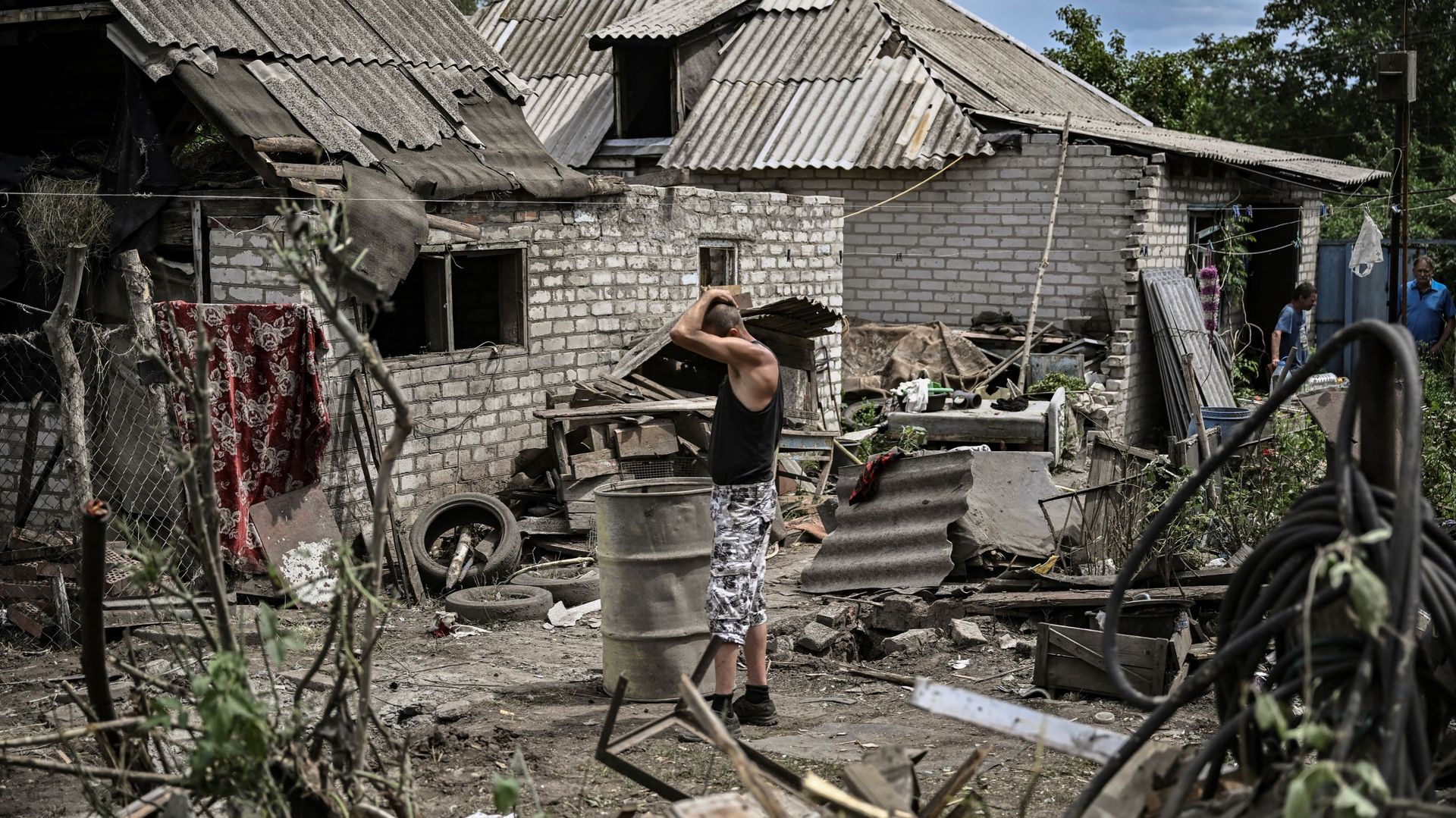 Maksym Katerin se tient dans la cour de sa maison endommagée après que sa mère et son beau-père ont été tués lors d’un bombardement dans la ville de Lysychansk, dans la région de Donbas, dans l’est de l’Ukraine, le 13 juin.