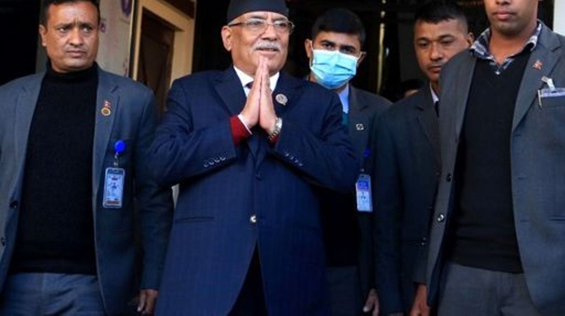 Nepal’s former guerrilla leader Pushpa Kamal Dahal (2L), better known by his nom de guerre Prachanda gestures to media representatives as he leaves for the president’s office to claim majority for his appointment as the new prime minister, in Bhaktapur on