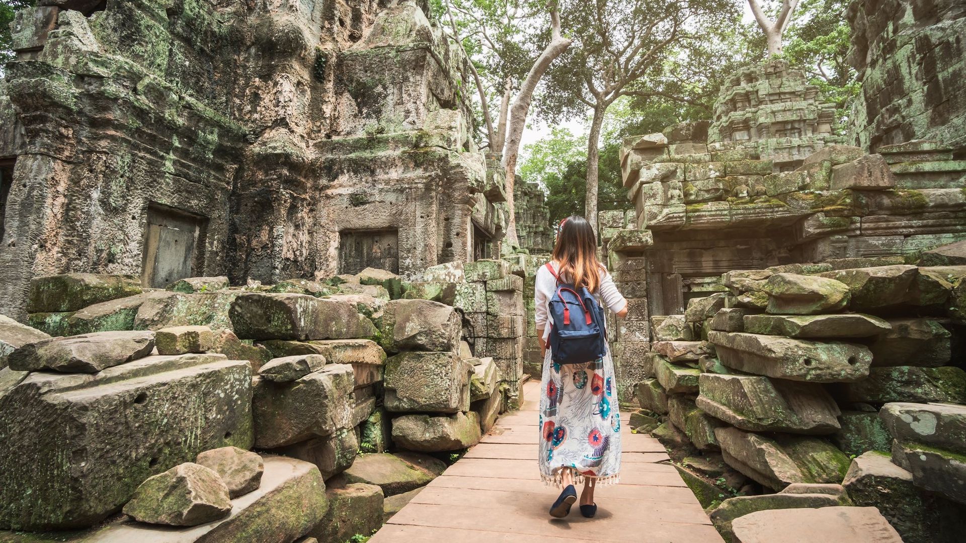 Rear View Of Woman Visiting Old Ancient Temples