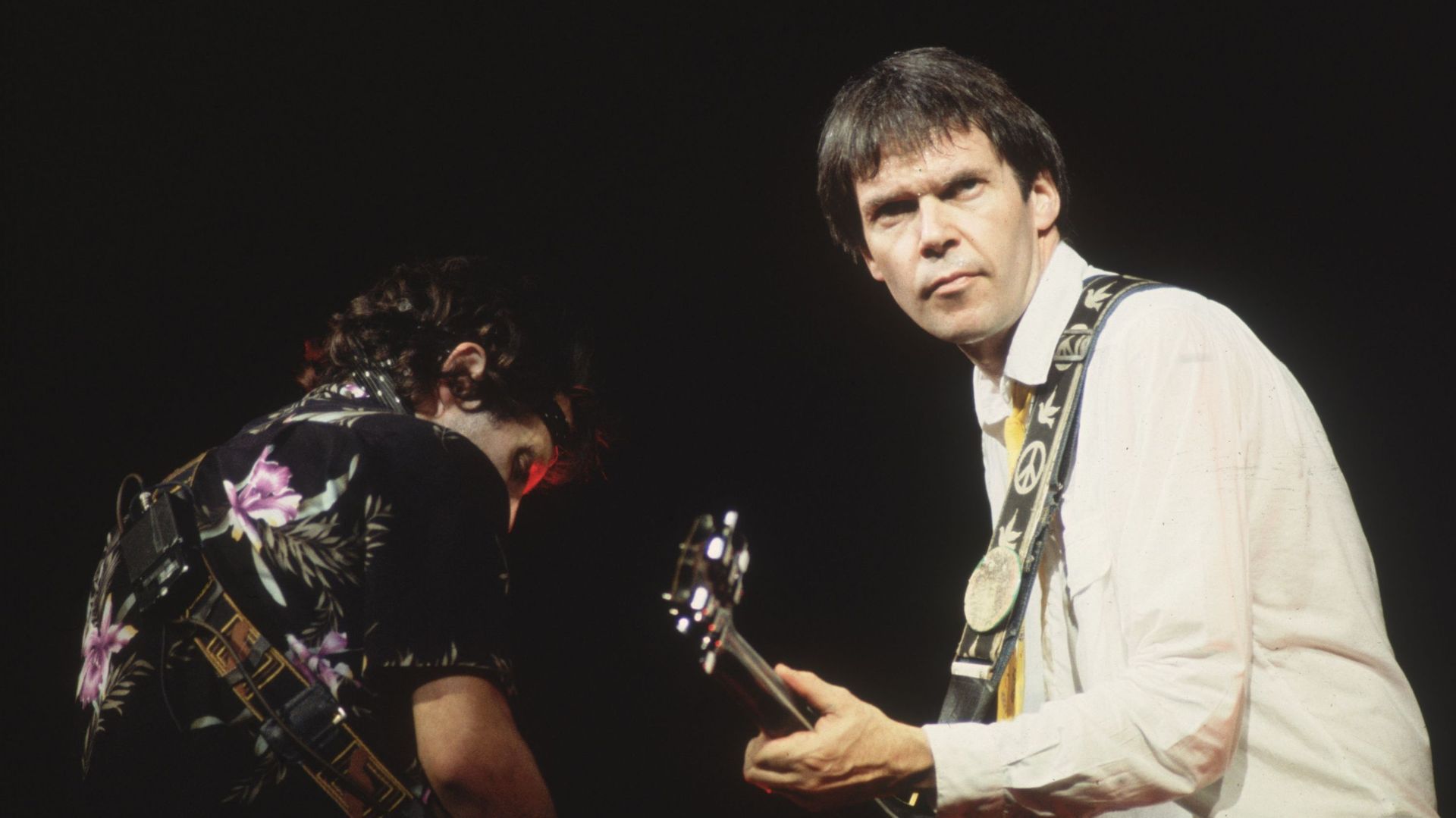 28th September 1982: Canadian singer, songwriter and guitarist, Neil Young playing at Wembley Arena, London, with fellow guitarist Nils Lofgren (left). (Photo by Hulton Archive/Getty Images)
