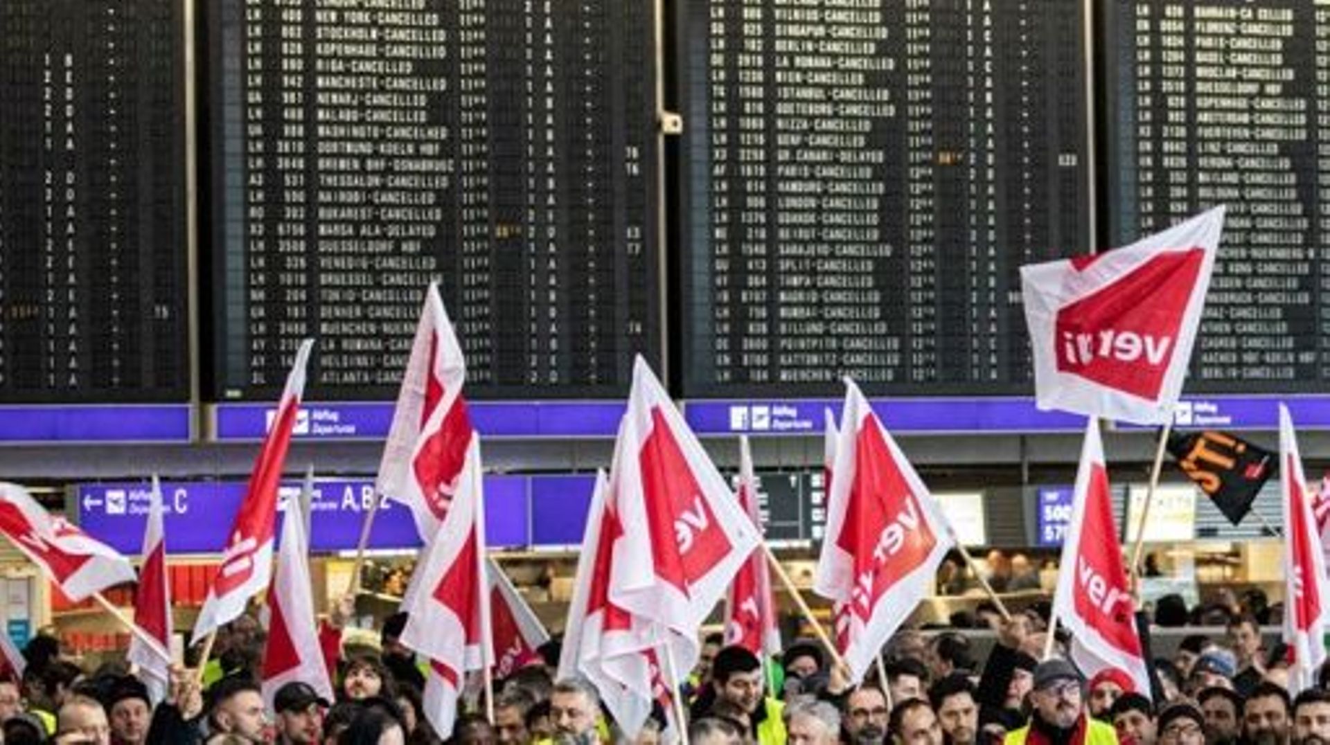 Protesters and members of trade union ver.di demonstrate as they stage a strike, at Frankfurt Airport in Frankfurt am Main, western Germany, on February 17, 2023.  Travellers faced flight delays and cancellations as workers at seven airports in Germany we