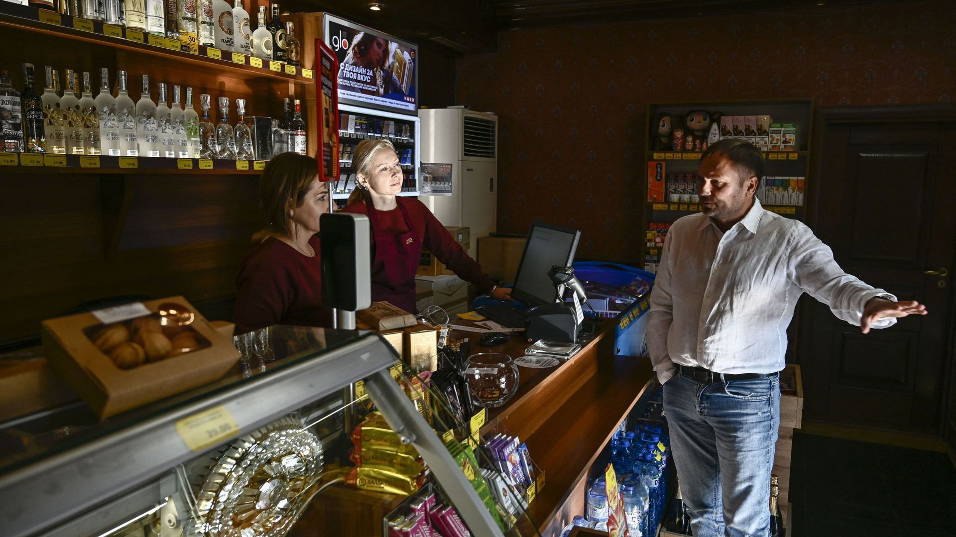 Anna Lasho et Oksana Shurdova, ukrainiennes, parlent avec le propriétaire du magasin russe où elles travaillent, Viktor Bakurevic, à Varna, le 25 novembre 2022.