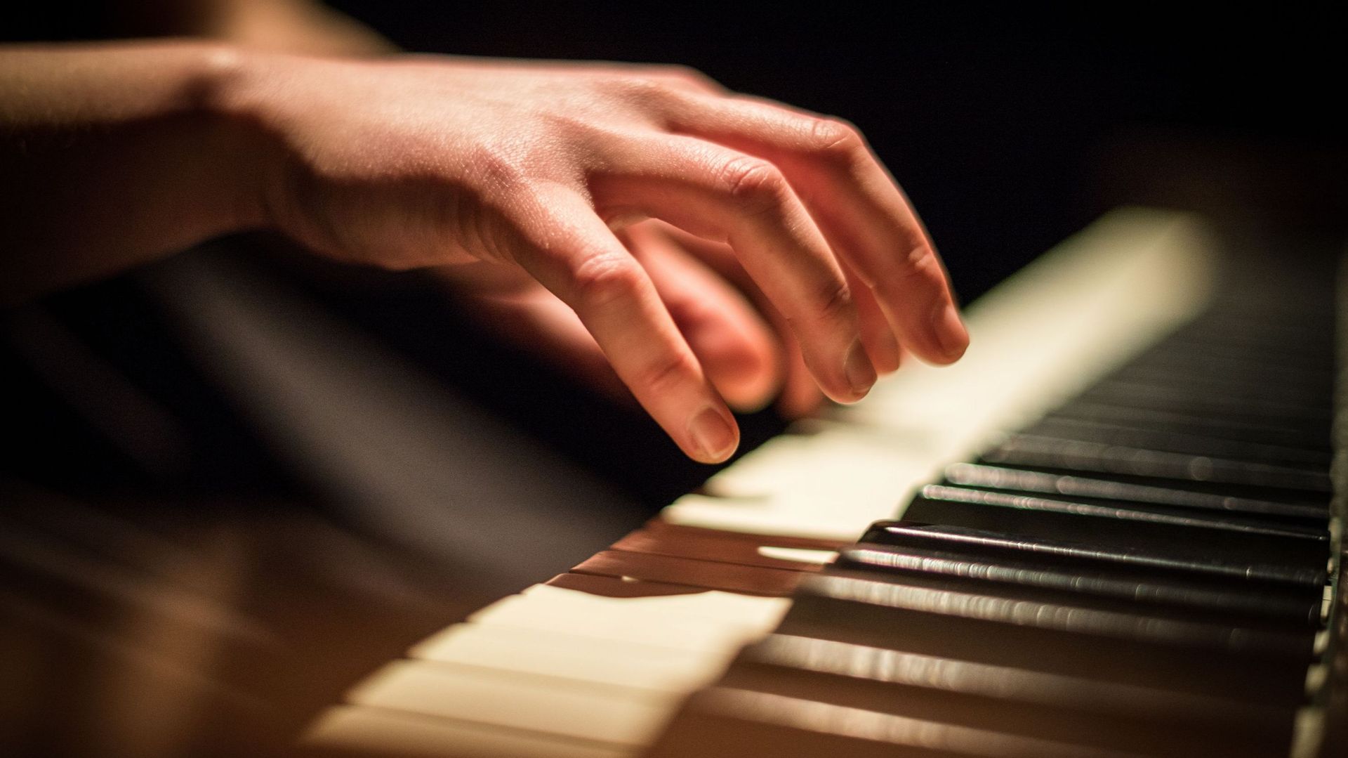 Close-Up Of Hands Playing Piano