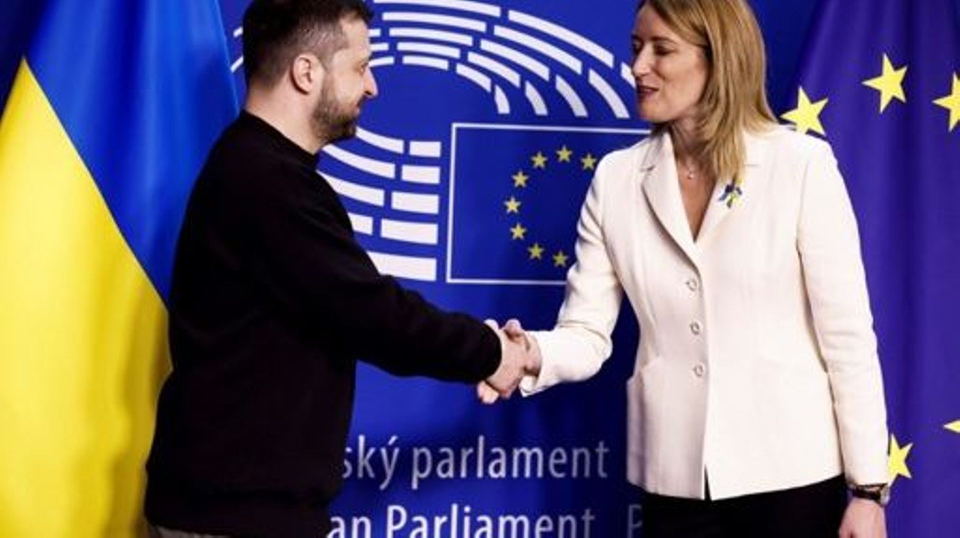 Ukraine's president Volodymyr Zelensky (L) shakes hands with European Parliament President Roberta Metsola as he arrives for a summit at EU parliament in Brussels, on February 9, 2023. Ukraine's President is set to attend an EU summit in Brussels on Febru