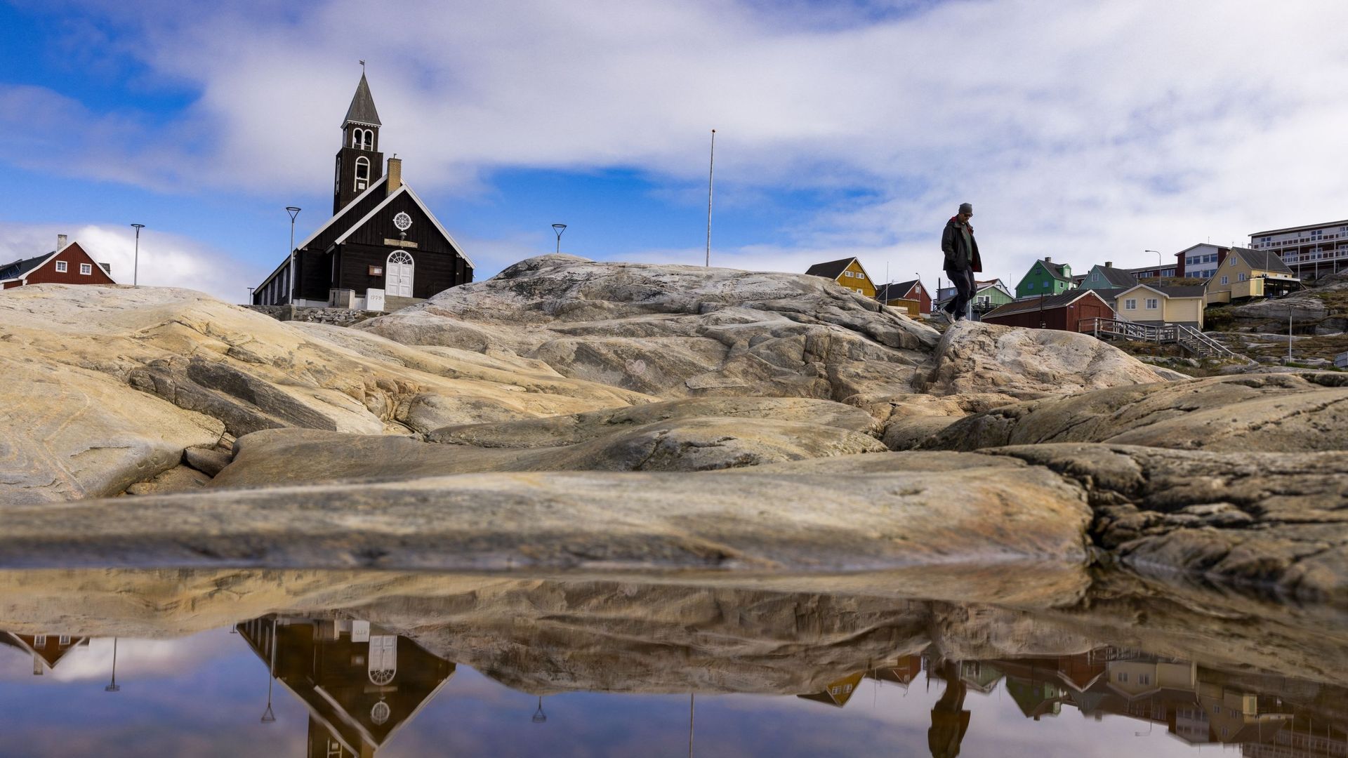 L'église se reflète dans une flaque d'eau à Ilulissat, dans l'ouest du Groenland, le 27 juin 2022.