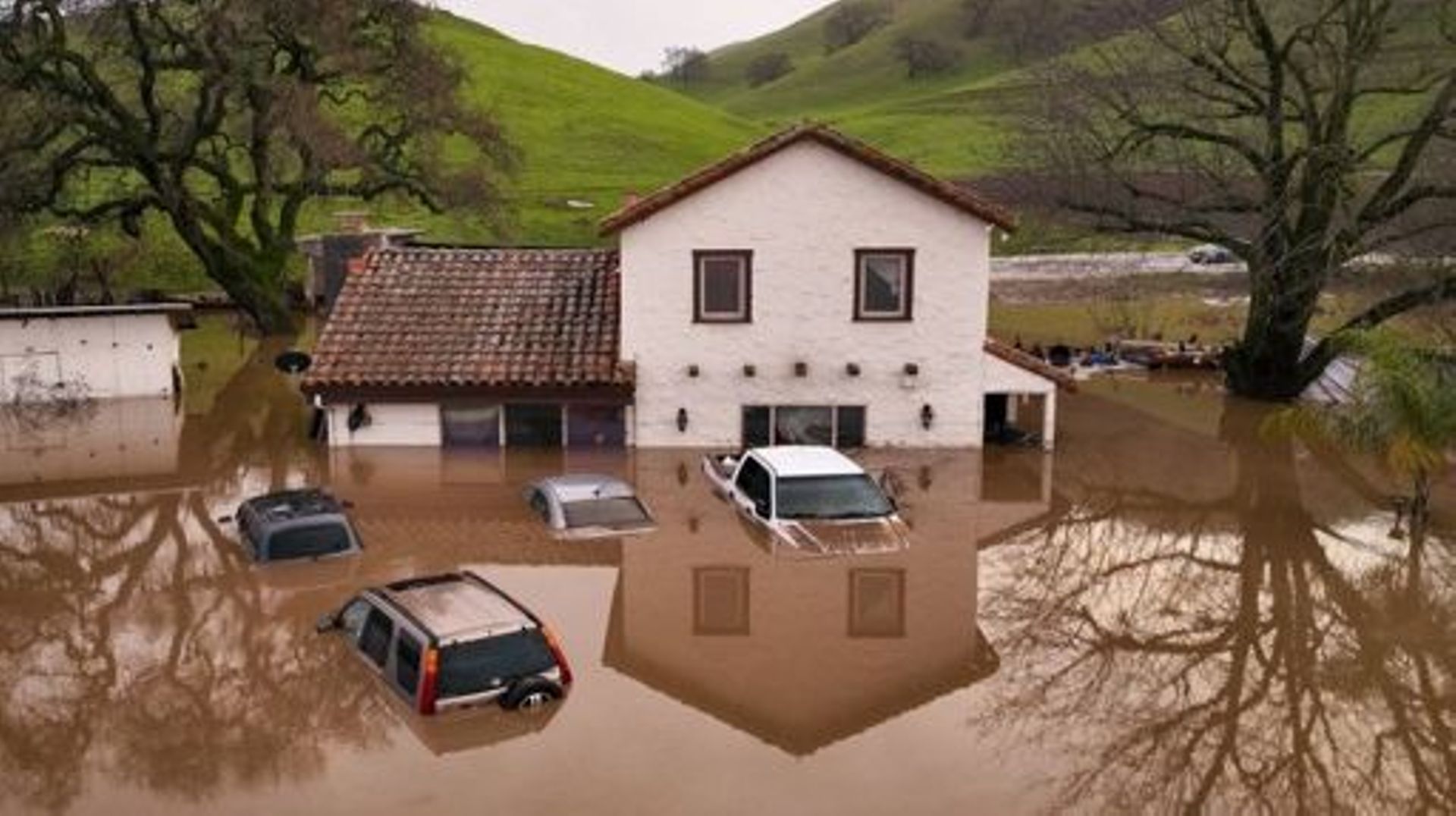 A flooded house is seen partially underwater in Gilroy, California, on January 09, 2023. Heavy rain lashed water-logged California Monday, with forecasters warning of floods as a parade of storms that have killed 12 people battered the western United Stat