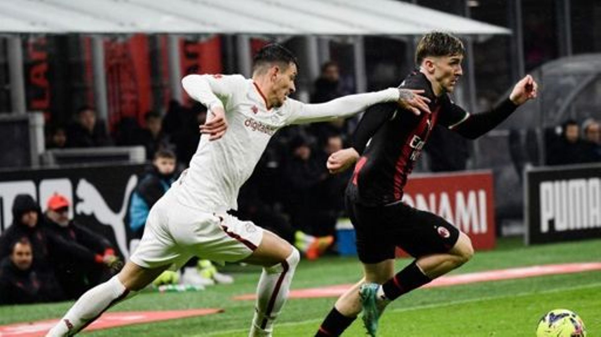 AS Roma's Brazilian defender Roger Ibanez (L) fights for the ball with AC Milan's Belgian forward Alexis Saelemaekers during the Italian Serie A football match between AC Milan and AS Roma, at the San Siro stadium in Milan, on January 8, 2023.  Filippo MO