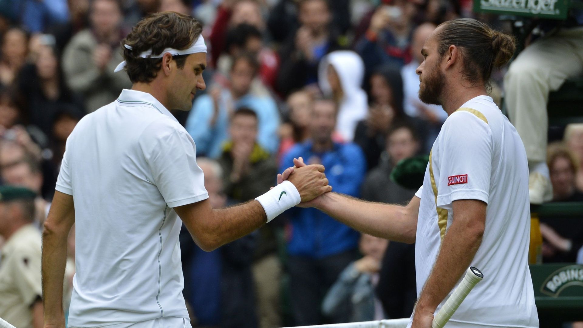Roger Federer et Xavier Malisse, à Wimbledon, en 2012