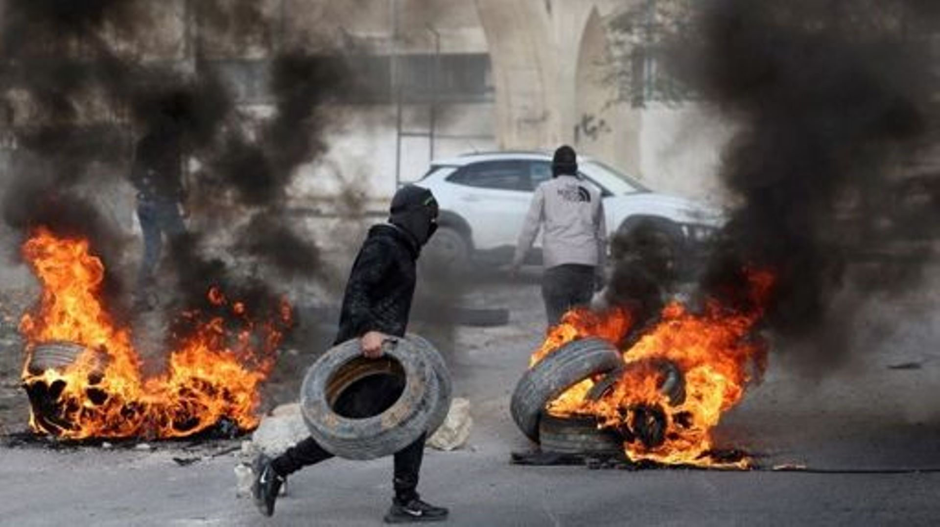 Palestinian protesters burn tyres to block a road leading into Jericho in the occupied West Bank, on February 6, 2023, following a raid in town by Israeli forces. Israeli forces on February 6 killed five alleged Palestinian gunmen in a raid in the occupie