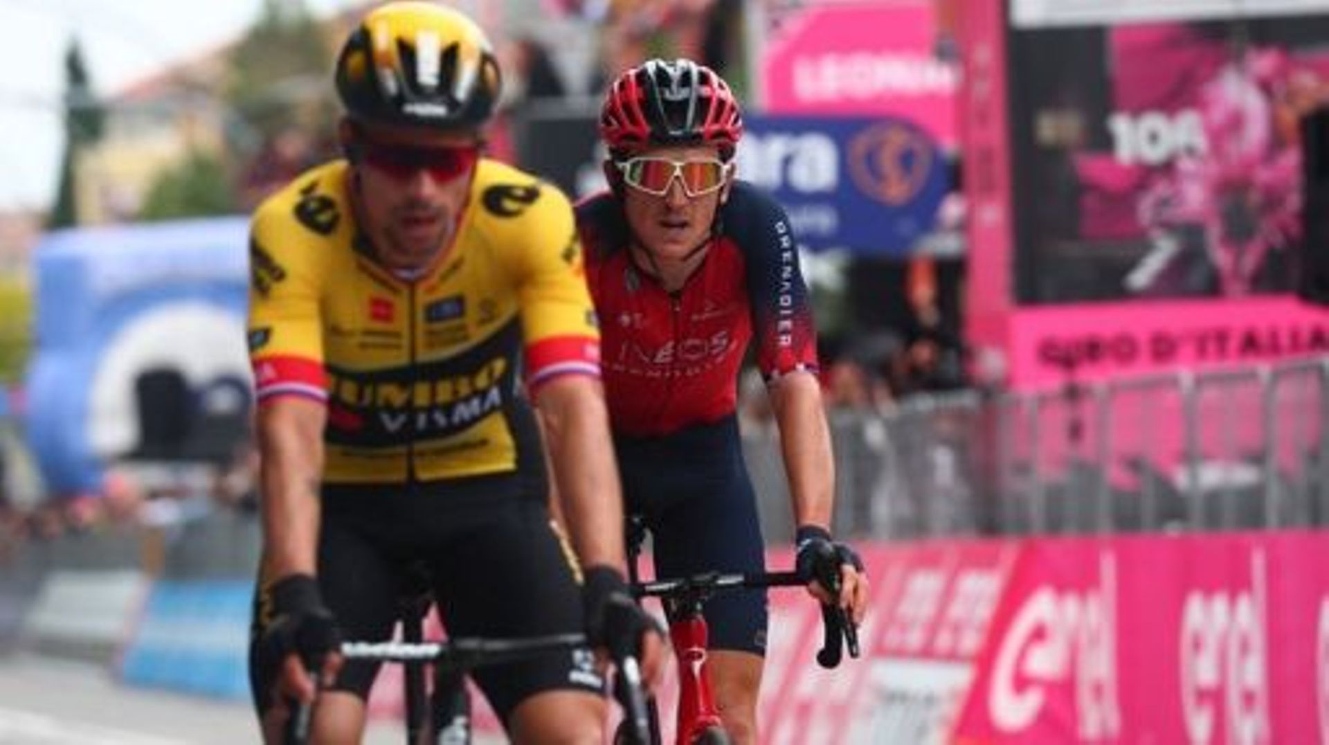 Jumbo-Visma’s Slovenian rider Primoz Roglic (L) and INEOS Grenadiers’s British rider Geraint Thomas, cross the finish line to respectiveely place 11th and 12th of the eighth stage of the Giro d’Italia 2023 cycling race, 207 km between Terni and Fossombron