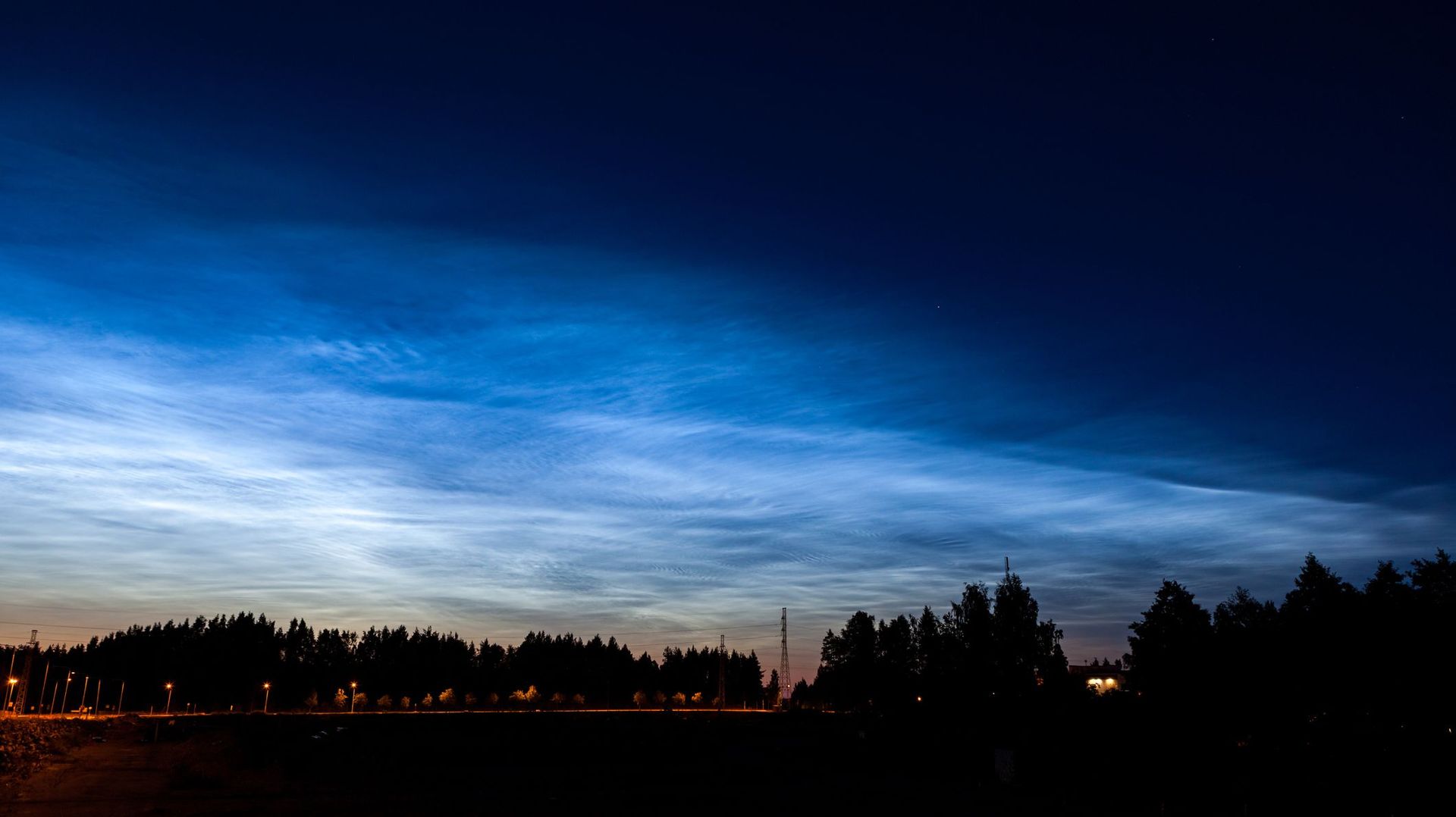 Noctilucent clouds glowing at night sky