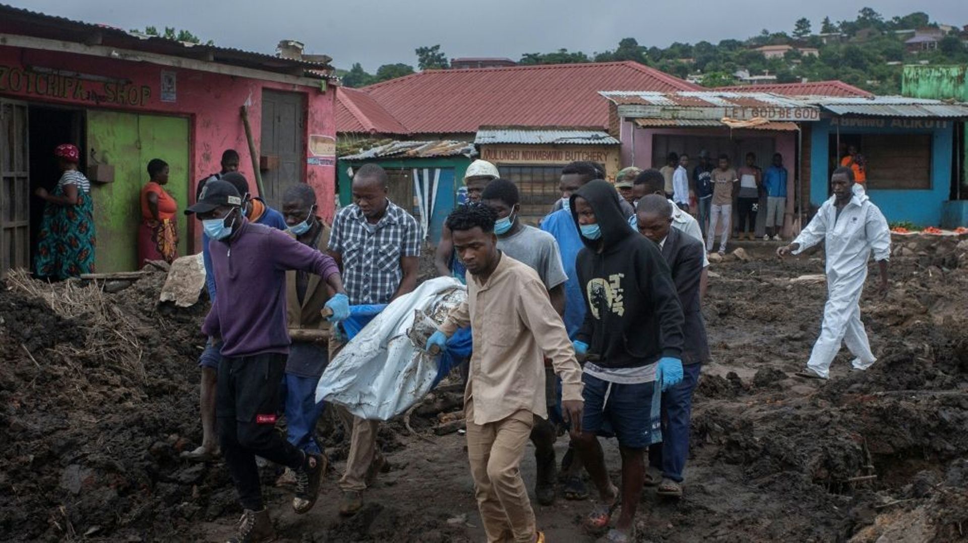 Des hommes évacuent les corps de victimes de coulées de boue survenues lors du passage du cyclone tropical Freddy à Blantyre, le 17 mars 2023