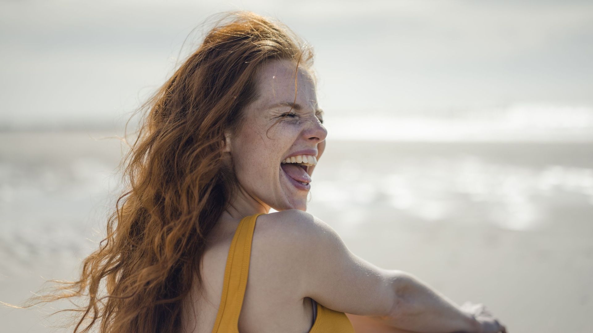 Laughing woman having fun on the beach
