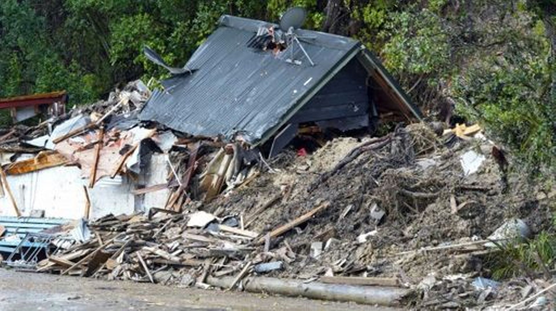 A general view of a damaged house after a storm battered Titirangi, a suburb of New Zealand’s West Auckland area, on February 13, 2023. Thousands of homes in New Zealand were without power and flights were grounded Monday as a tropical storm lashed the no